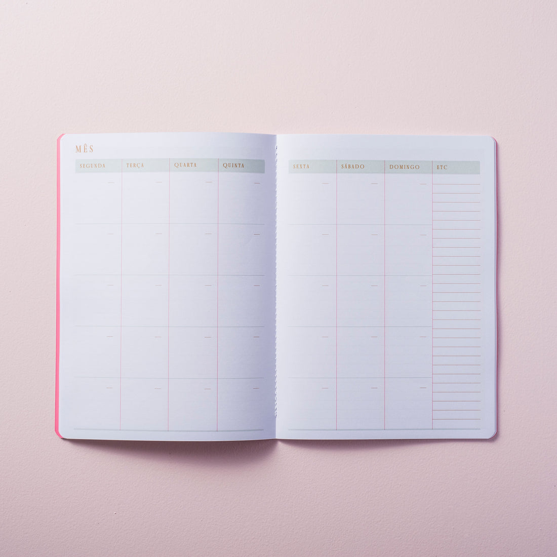 visão mensal do caderno de planejamento mensal sobre fundo liso rosa